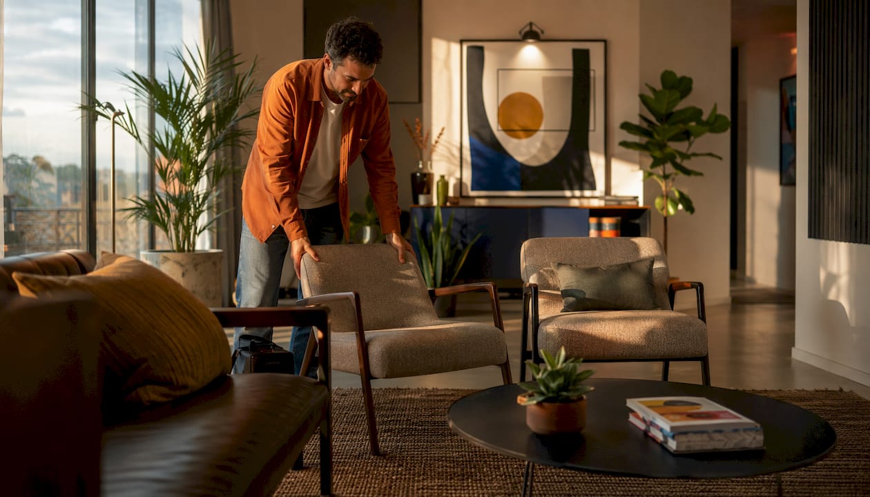 How to arrange furniture artfully: renter-friendly layouts 2 Man arranging seating cluster for better room flow in office