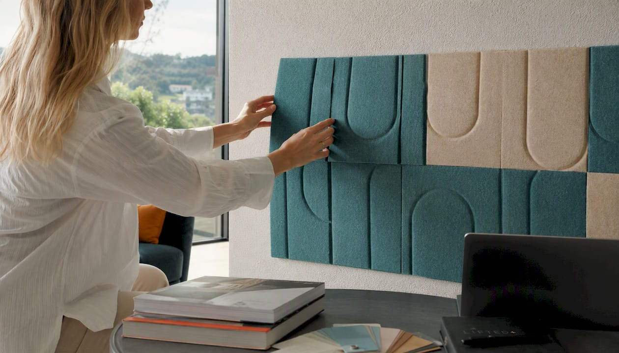 Vibrant wall art for decorators: no-drill colour without commitment 2 Hands attaching removable felt wall panel