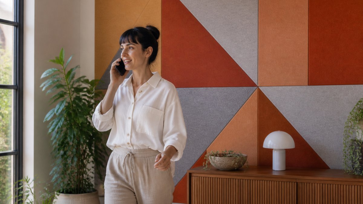 Recycled PET Felt Wall Panels Review: What Buyers Should Know 2 Professional on a video call in a home office with geometric felt wall panels behind them