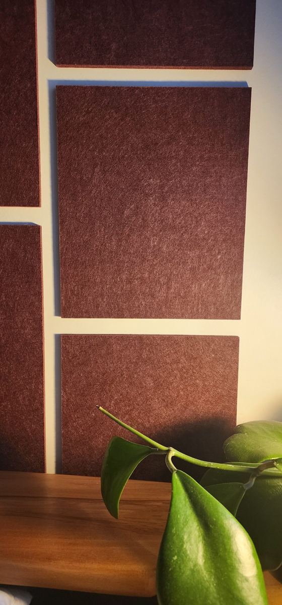 No Holes 2 Close-up of textured Oxblood PET felt panels on a painted wall